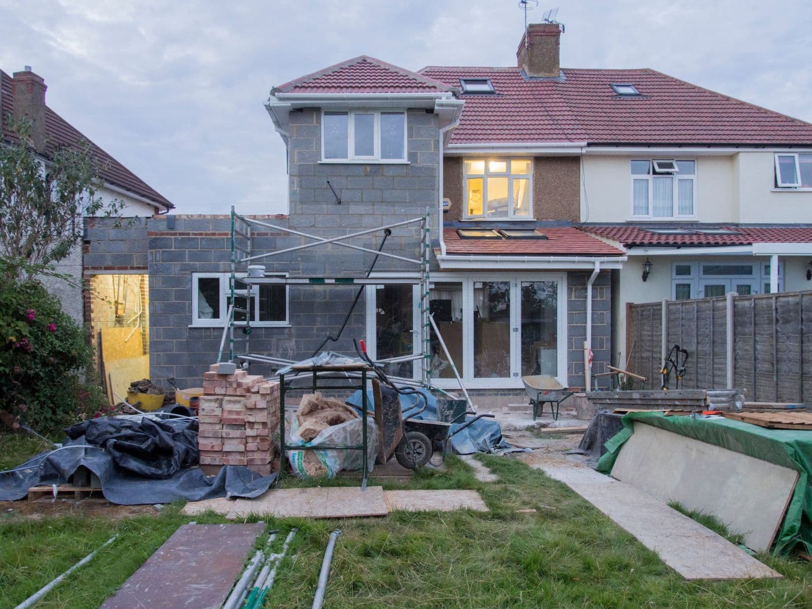 A suburban house undergoing major renovations with scaffolding